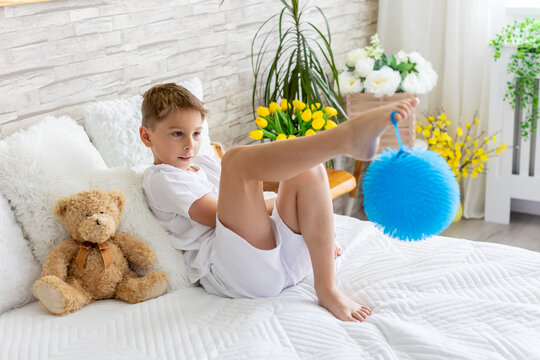Cute little preschool child, cute blond boy, playing in bed with many teddy bears, handmade amigurumi toys, enjoying toy game