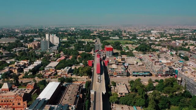 Drone Shot of Elevated Bus Transit Track Leading Toward Historic Church and Stadium Rawalpindi