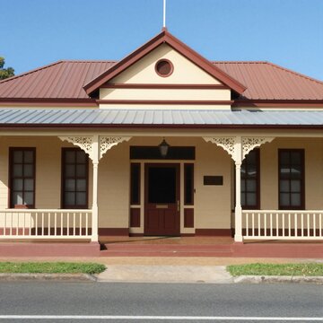 Historic Queenslander architecture with a prominent veranda and ornate detailing