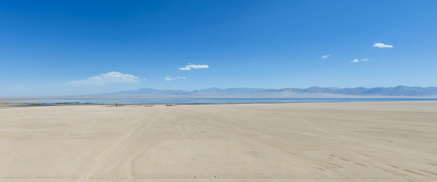 Arid Desert Landscape Featuring High Altitude Saline Lake And Distant Mountains