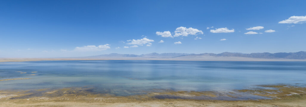 Aerial Close-up of High Altitude Sugan Lake and Distant Mountains