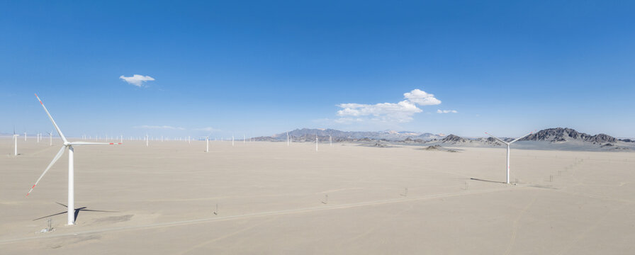 Panoramic Aerial View Of Wind Turbines In Gobi Desert With Heidu Mountains