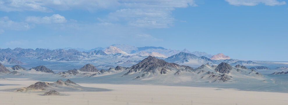Panoramic View Of Layered Mountain Range In Gobi Desert Plateau