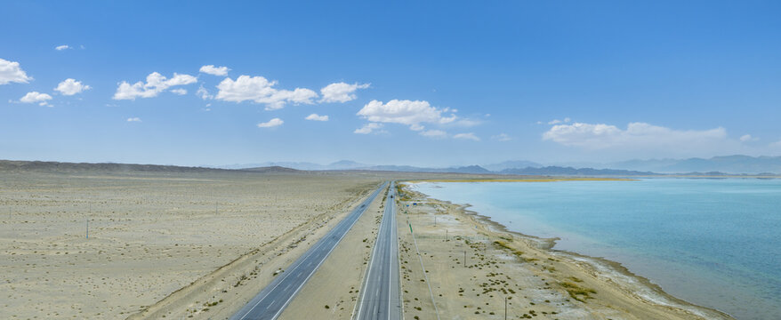 Aerial View Of Highway Alongside Lake In Gobi Desert