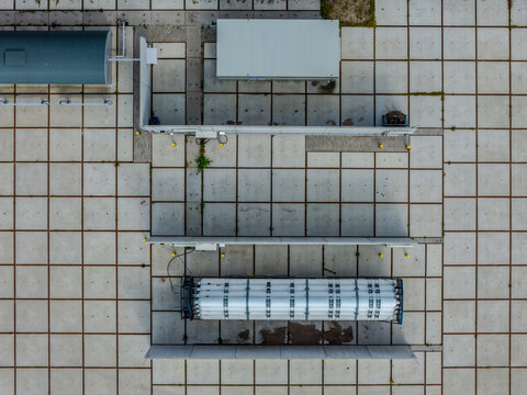 Aerial view of a hydrogen pilot project facility featuring storage tanks and industrial infrastructure on a concrete grid surface in Hoogeveen, Drenthe, Netherlands.
