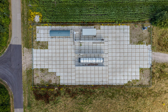Aerial view of a hydrogen pilot project infrastructure with storage tanks and concrete paving in Hoogeveen, Drenthe, Netherlands.