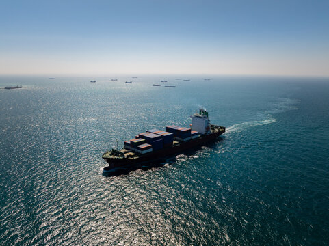 Large Container Ship Navigating Deep Blue Ocean Waters Near Si Racha Chon Buri Thailand During A Sunny Day For Global Trade And Supply Chain Transport