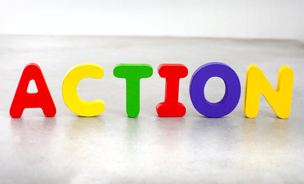 Action concept spelled with colorful wooden alphabet letters