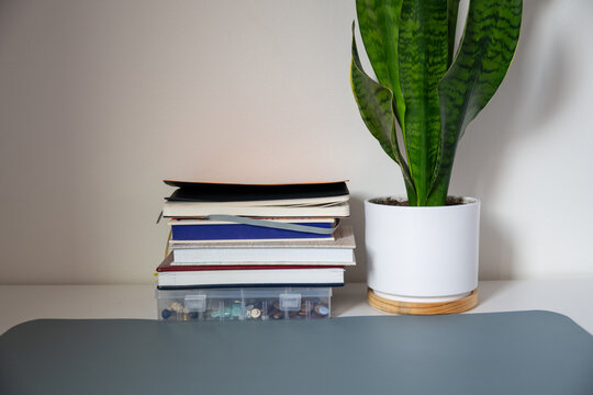 Organized stack of notebooks and journals on minimalist home office desk with copy space