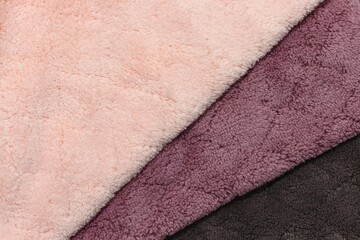 Three fluffy fabrics overlap pattern background, pink magenta and black © Boonsawad
