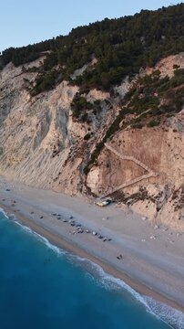 Smooth drone descent over the iconic staircase to Egremni Beach, Lefkada, Greece, revealing dramatic white cliffs, turquoise Ionian Sea, and one of the island&rsquo;s most spectacular beaches 
