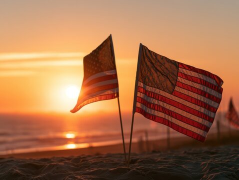 Two flags waving at sunset near the ocean horizon