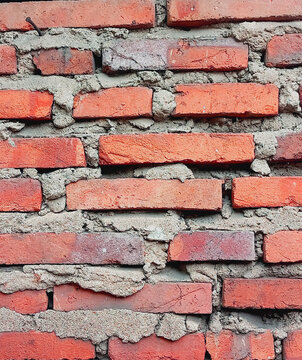 Red Brick Wall Texture with Rough Gray Cement and Construction Background