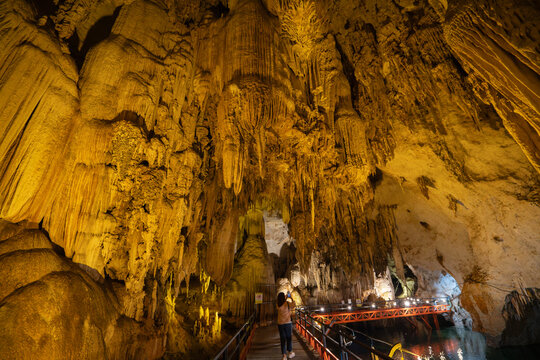 Illuminated limestone cave with spectacular stalactites and underground walkway at Tham Pla Chuem Cave, Thakhek, Laos
