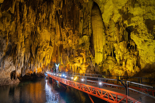 Illuminated limestone cave with spectacular stalactites and underground walkway at Tham Pla Chuem Cave, Thakhek, Laos
