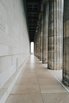 Vertical view through the Doric colonnade of the Walhalla memorial near Regensburg towards a bright opening