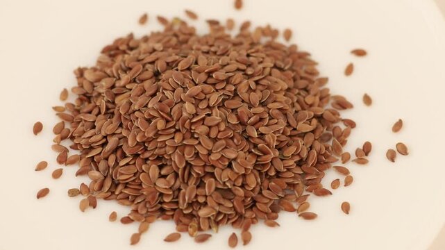 Flax seeds on a plate in four close-up frames