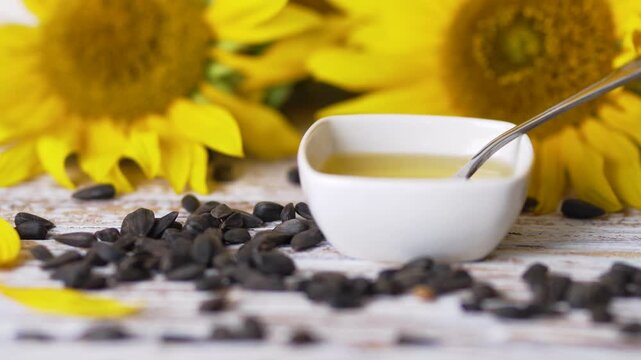 Stirring organic sunflower oil with spoon in bowl video clip