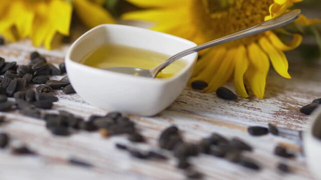 Kitchen spoon inside white bowl filled with cooking oil stock footage