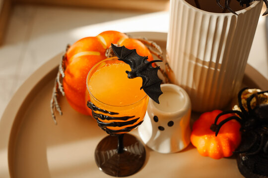 Gathering for Halloween with decorations drinks and festive elements in a cozy indoor setting during the autumn season