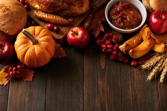 Thanksgiving Rustic Flat Lay with Roasted Turkey Pumpkin Apples Wheat and Copy Space on Dark Wooden Background