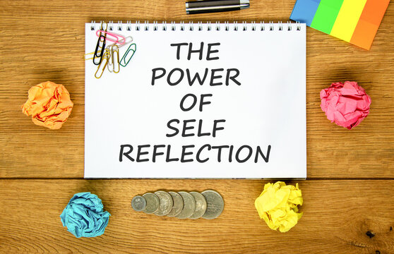 Self reflection symbol. Concept words The power of self reflection on beautiful white note. Beautiful wooden background. Colored paper. Business the power of self reflection concept. Copy space.