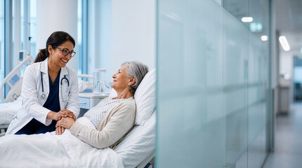 Fototapeta premium Compassionate female doctor holding hands and comforting an elderly patient in a modern hospital room