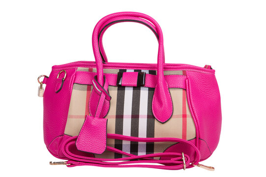 Pink leather women handbag with plaid check pattern insert isolated on white background. Stylish fuchsia female purse with shoulder strap studio shot