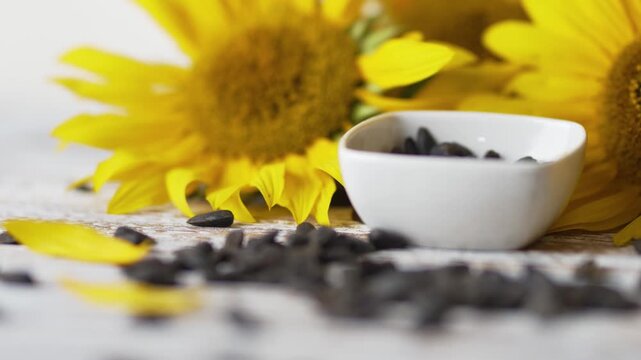 Harvested sunflower seeds in bowl on rustic wooden background footage