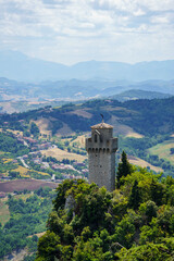 Fototapeta premium Montale Tower of San Marino on Rocky Peak Above Misty Apennine Landscape
