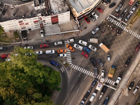 Aerial view of a busy intersection with cars and trucks navigating a yellow box junction in Santo Domingo, Distrito Nacional, Dominican Republic.