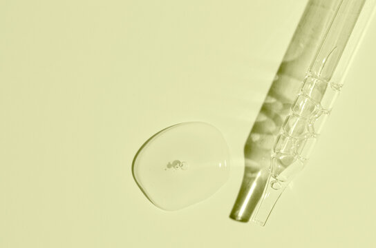 Cosmetic transparent product on a yellow background. A serum or gel or cream.