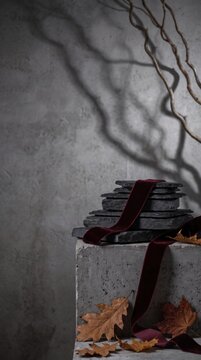 Stone product podium with maroon fabric and leaf shadows for ecommerce autumn background and copy space seasonal design platform