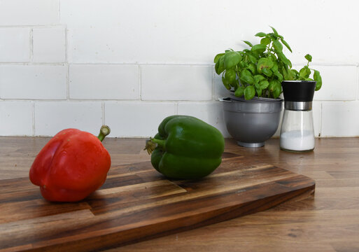 Fresh Vegetables and Fruit on a Chopping Board on a Kitchen Counter
