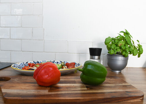 Fresh Vegetables and Fruit on a Chopping Board on a Kitchen Counter