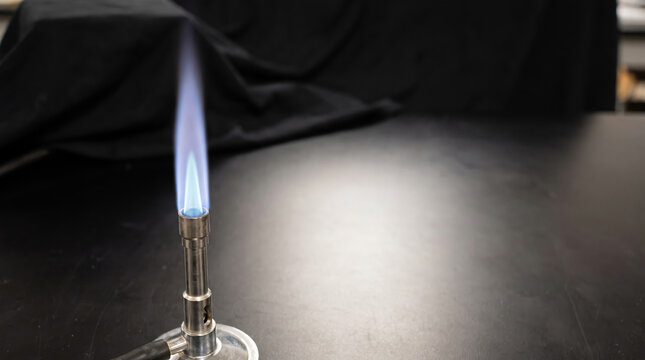Blue hydrogen flame burning steadily on a lab gas burner
