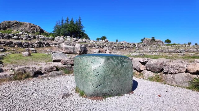 The famous smooth green nephrite stone block stands amid the ancient ruins of the Great Temple at Hattusa, Turkey.