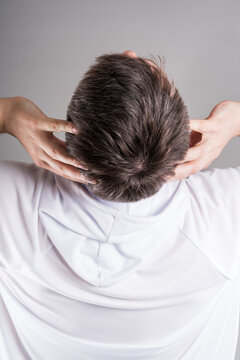 Headache and migraine, man with head pain on gray background