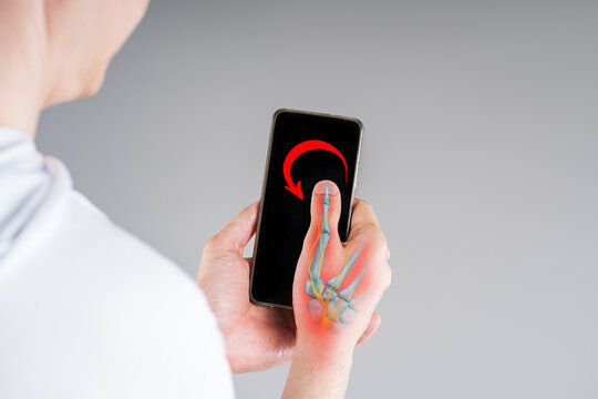 Close up of man using smartphone. Pain thumb with illustration anatomical joint, bones, nerves and red backlight