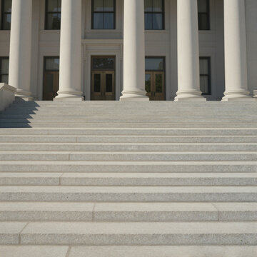 grand marble staircase leading to historical government building entrance in bright daylight