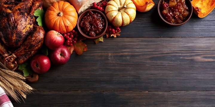 Thanksgiving Rustic Flat Lay with Roasted Turkey Pumpkin Apples Wheat and Copy Space on Dark Wooden Background