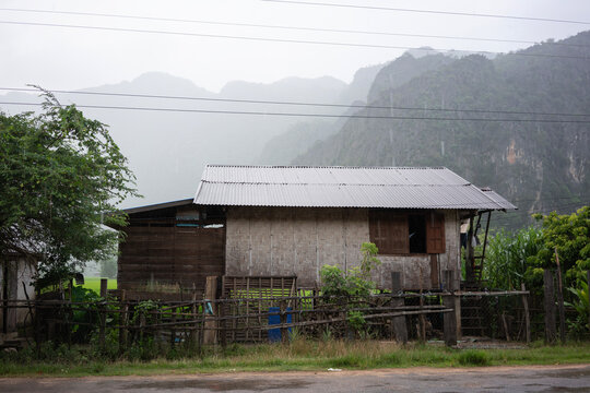 Traditional rural house in Kong Lor Village surrounded by limestone mountains in Khammouane Province, Laos