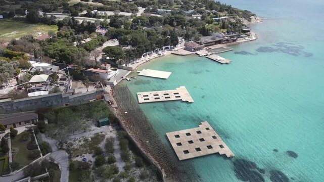 Aerial Drone View of Turquoise Bay with Floating Pier and Coastal Resort in Cesme Turkey 4K