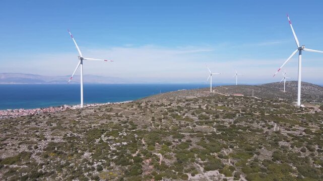 Aerial Drone View of Wind Turbines on Rocky Hillside with Aegean Sea Coastline, Cesme Turkey