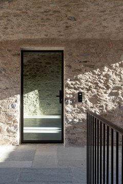 A detail of a French window with a beam of light on the walls.