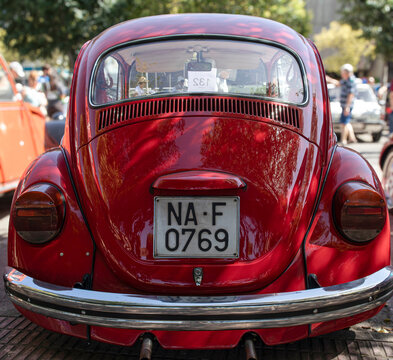 Tavernes Blanques, Spain - June 14, 2026. Bright red vintage Volkswagen Beetle parked at an outdoor auto exhibition with a Spanish license plate in view