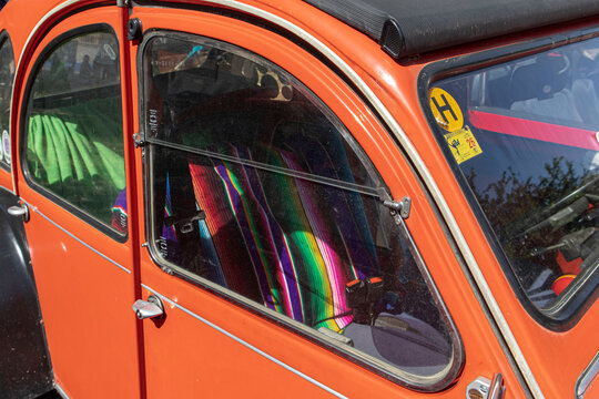 Tavernes Blanques, Spain - June 14, 2026. Side view of retro Citroen car showing colorful seats and bright interior on a sunny day