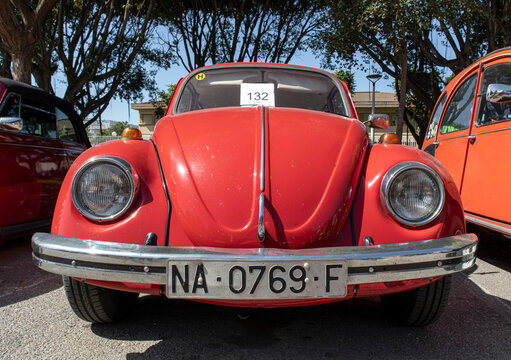 Tavernes Blanques, Spain - June 14, 2026. Classic red Volkswagen Beetle shows off its design and features at a car show in the afternoon sun