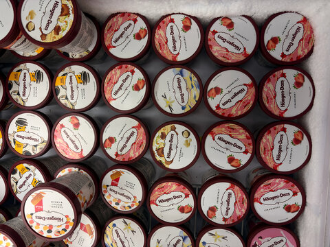An arrangement of various jars filled with colorful pasta sauces. Each jar has a distinct label featuring different flavors. The scene showcases a vibrant display of culinary options.