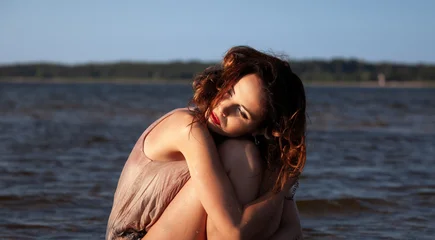 Woman sitting in water by the shore © misu
